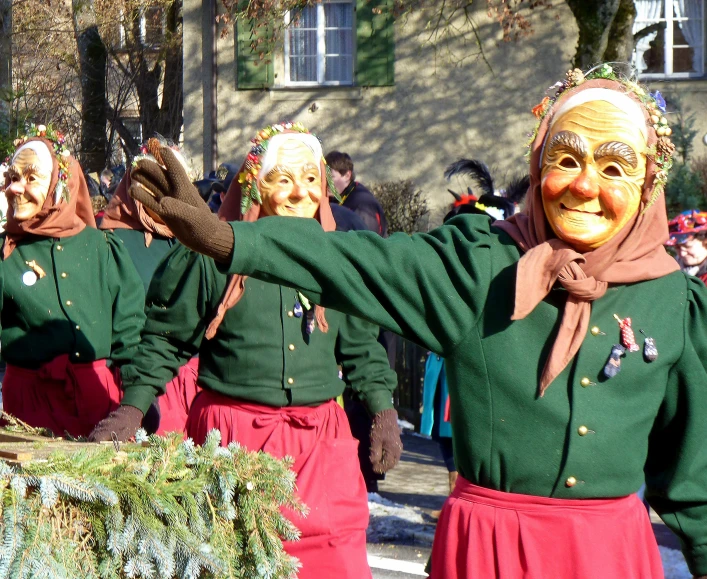 the group of women are marching along the street