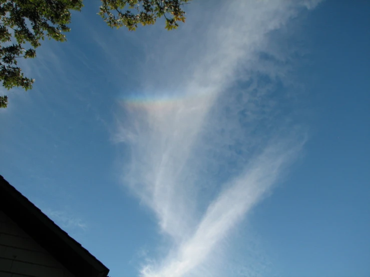 a rainbow is being viewed from a roof