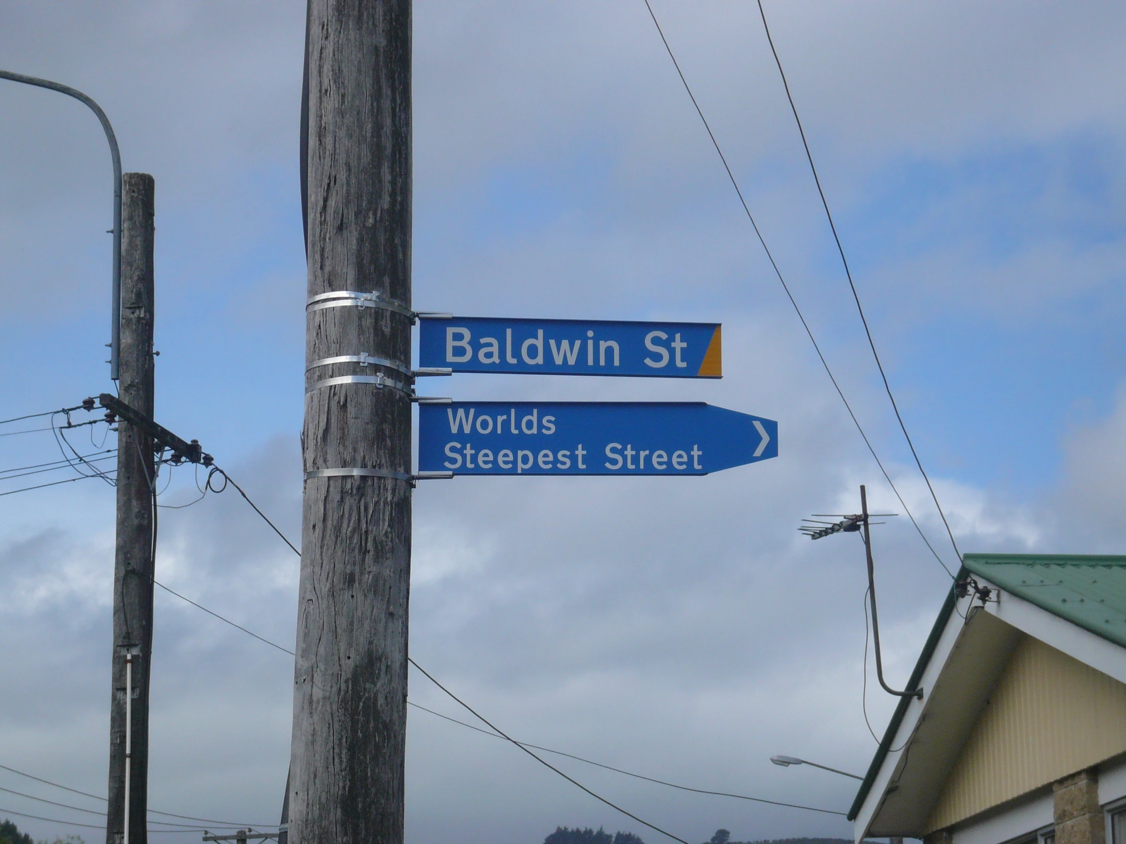 a street sign showing the direction of several roads
