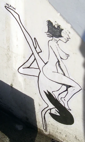 a graffiti covered wall with the outline of a woman holding a knife