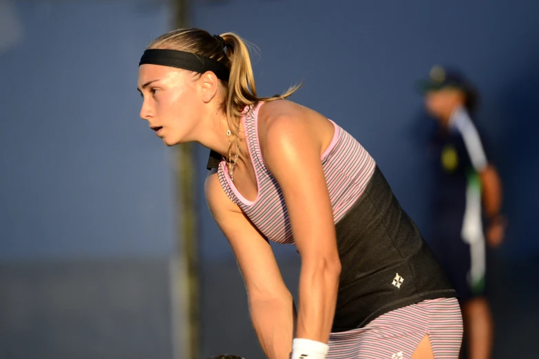 a women that is standing up holding a tennis racket