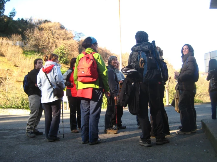 group of people standing together talking and smiling