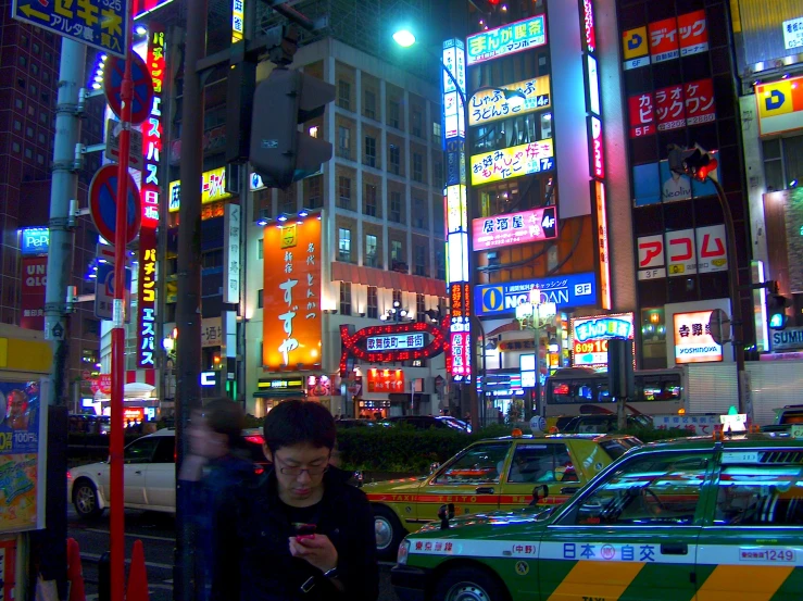 a couple of men standing in front of a busy street