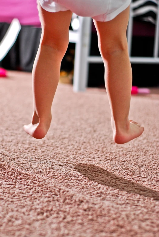 a small child is playing on the carpet