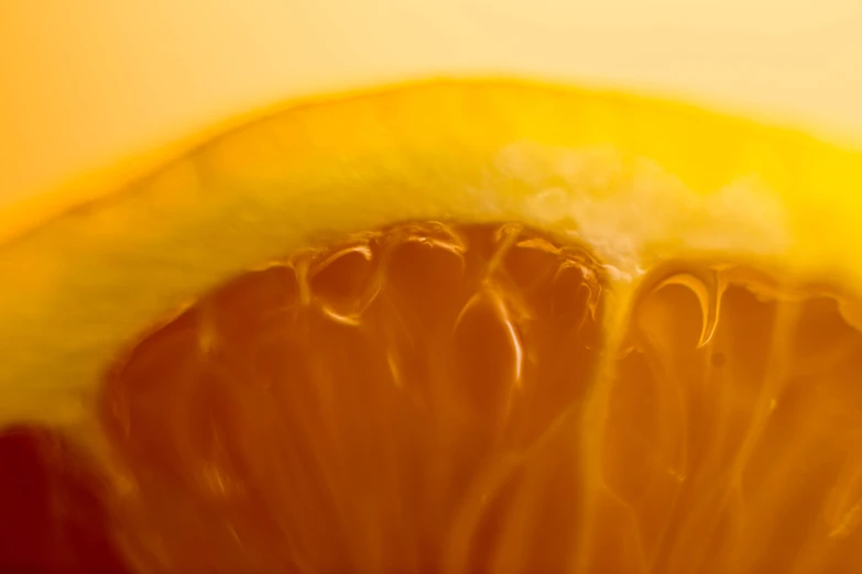 a yellow half - eaten lemon sitting on top of an orange