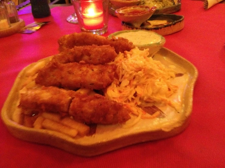 a plate of food on a table with people in the background