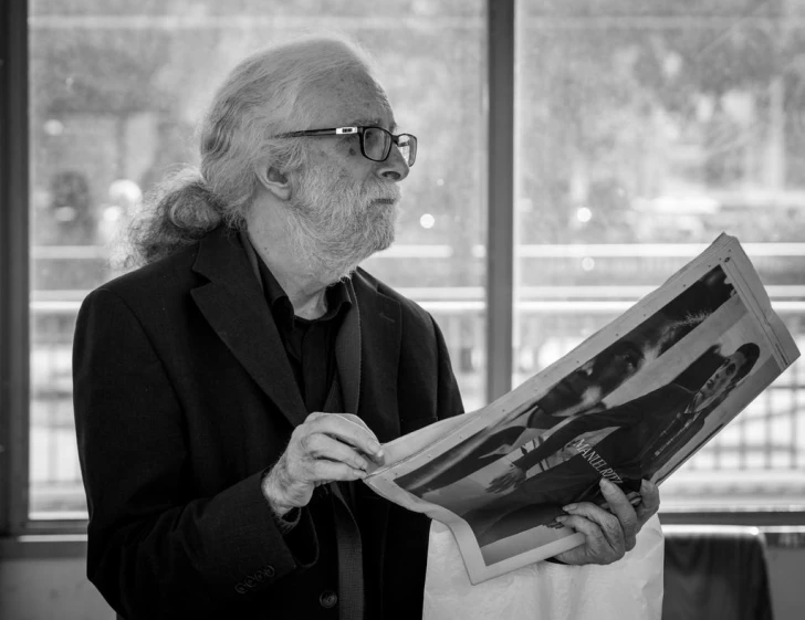 black and white pograph of a man reading a newspaper