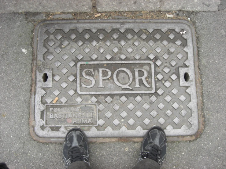 a sidewalk with a sign on it that says spqr