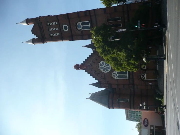 a tall building with two clocks and arches near a street