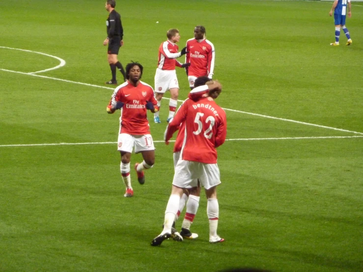 players are walking out onto the field during a soccer match