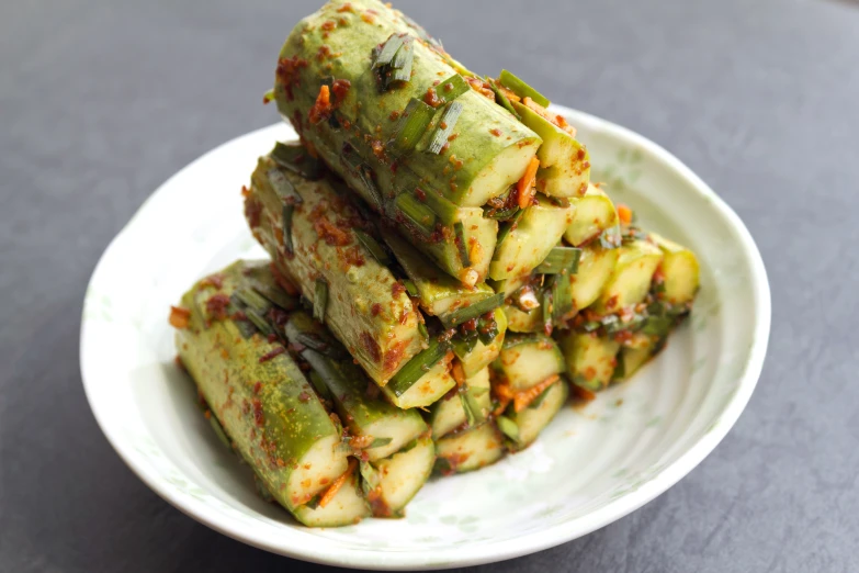 a pile of fried vegetables on a white plate