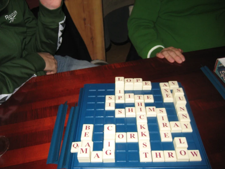 a family sits and looks at the words spelling tricquas