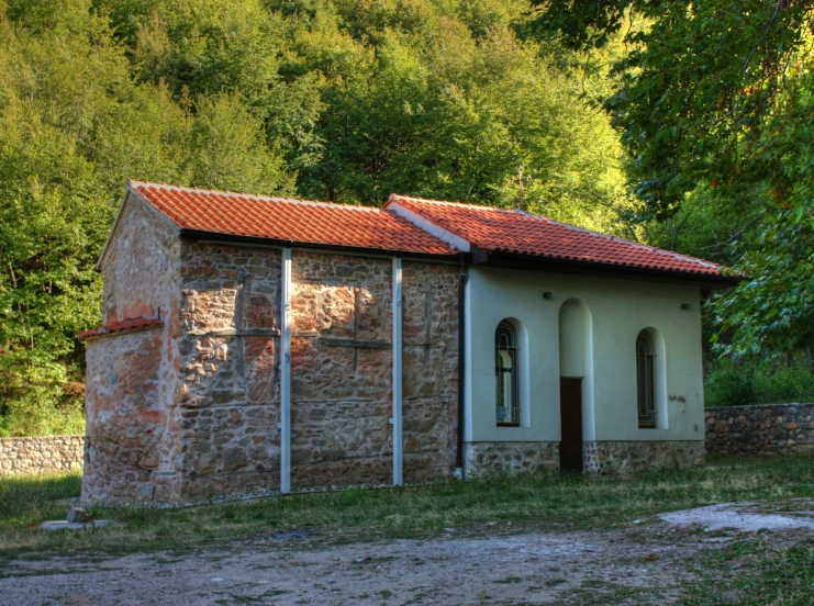 an old stone and tile building is seen