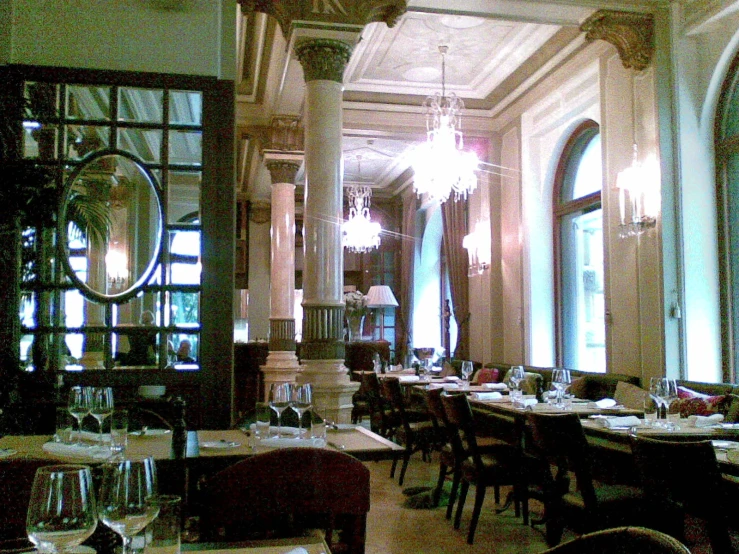 a large dining room with chandeliers hanging from the ceiling