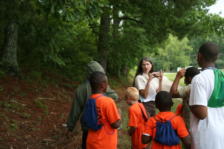 a group of children standing in front of two adults