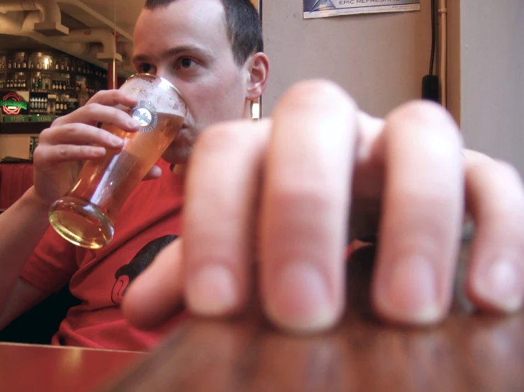 a man is holding up his glass to a beverage