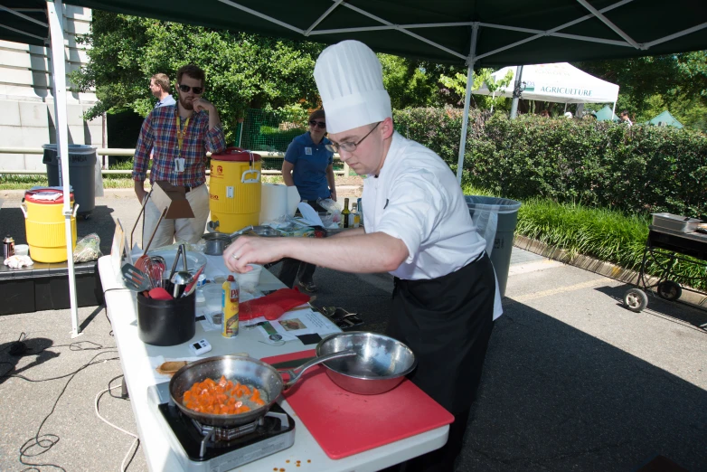 a chef prepares food at a picnic table