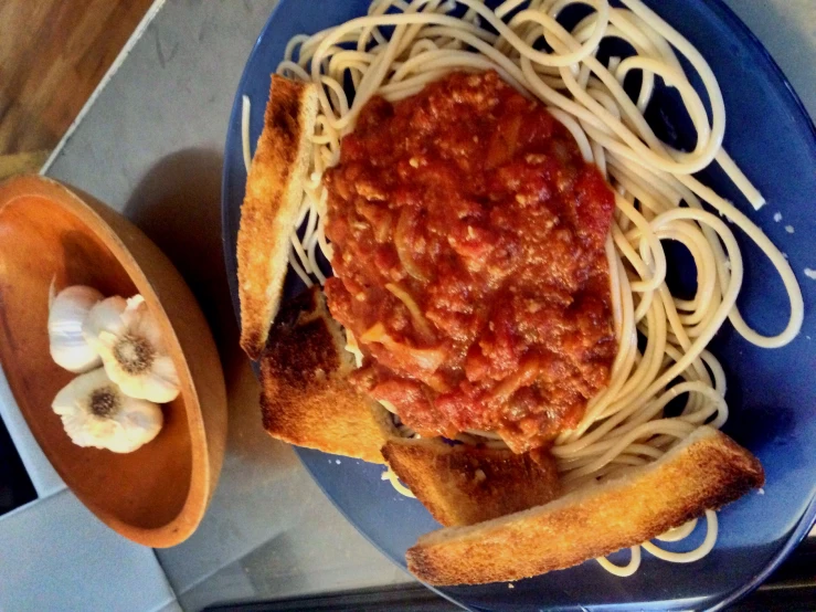 pasta is shown with a slice of bread on top of it