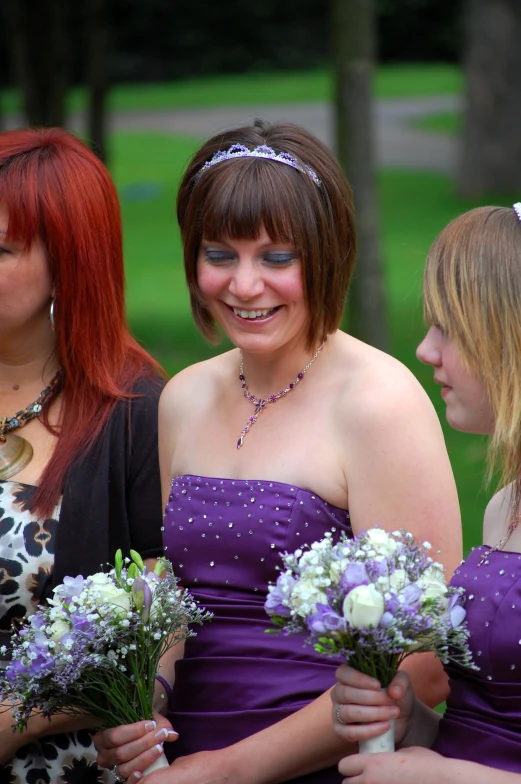 a group of bridesmaids in dresses and flowers