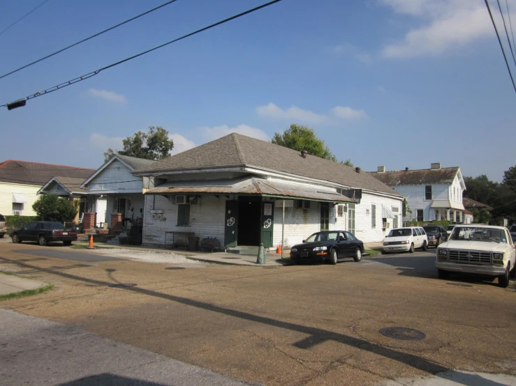 the two story houses have cars parked outside