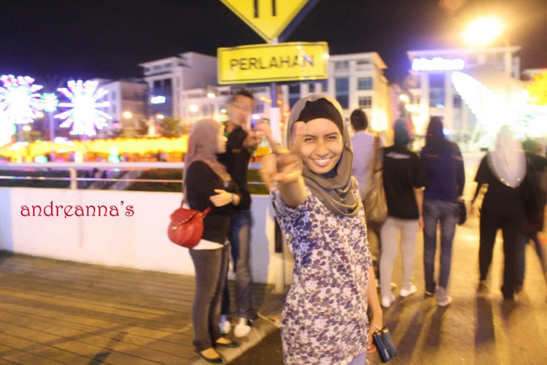 a woman posing for a picture at an outdoor fireworks event