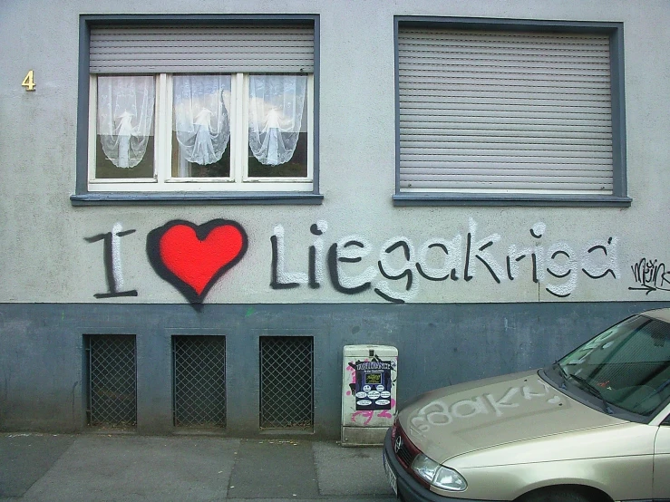 a van parked in front of a wall covered with graffiti