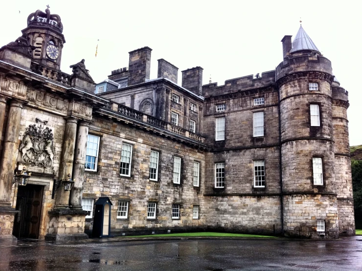 an old castle with a clock tower and courtyard