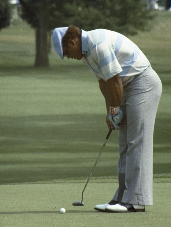 a man hitting a golf ball with a club