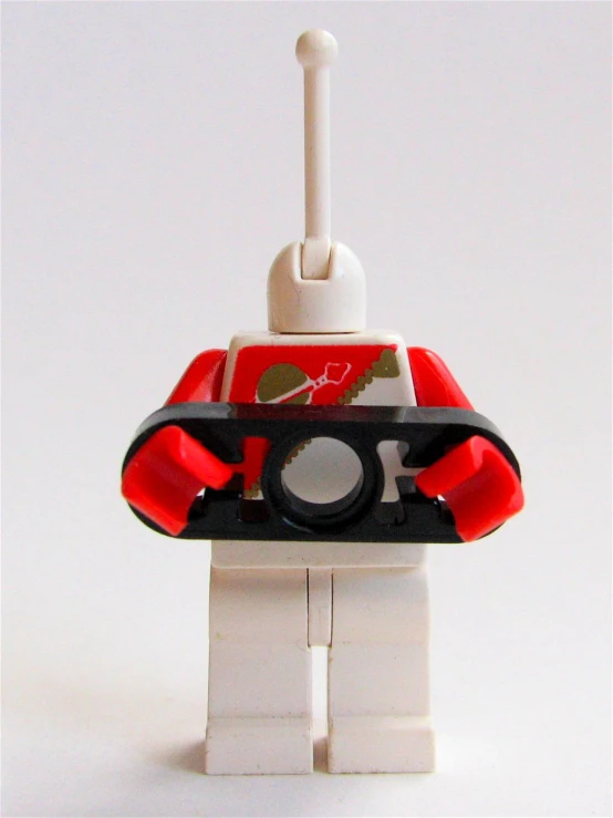 a red and white lego toy with a black camera