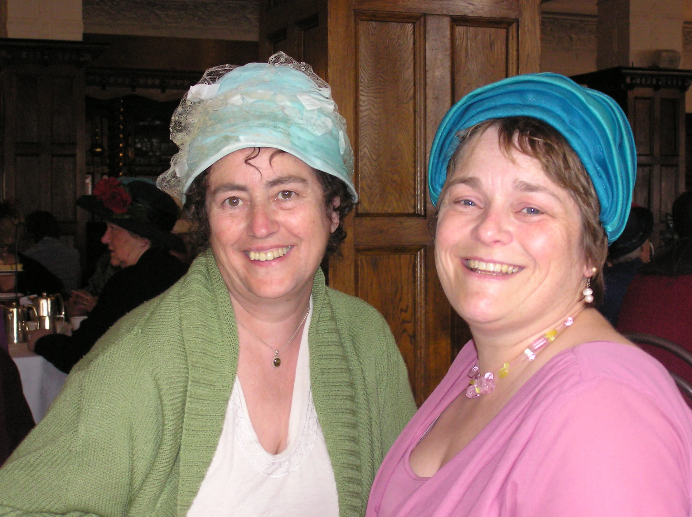 two woman in scrubs standing next to each other smiling