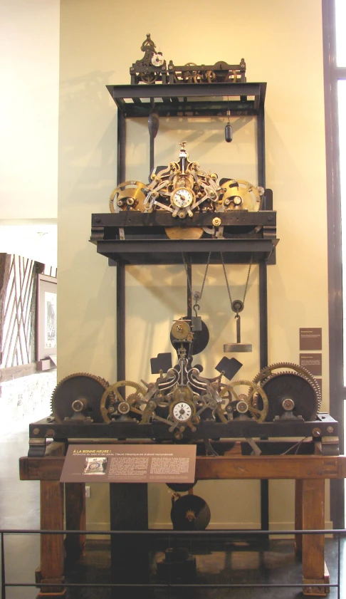 a clock mounted to a wall next to a display case