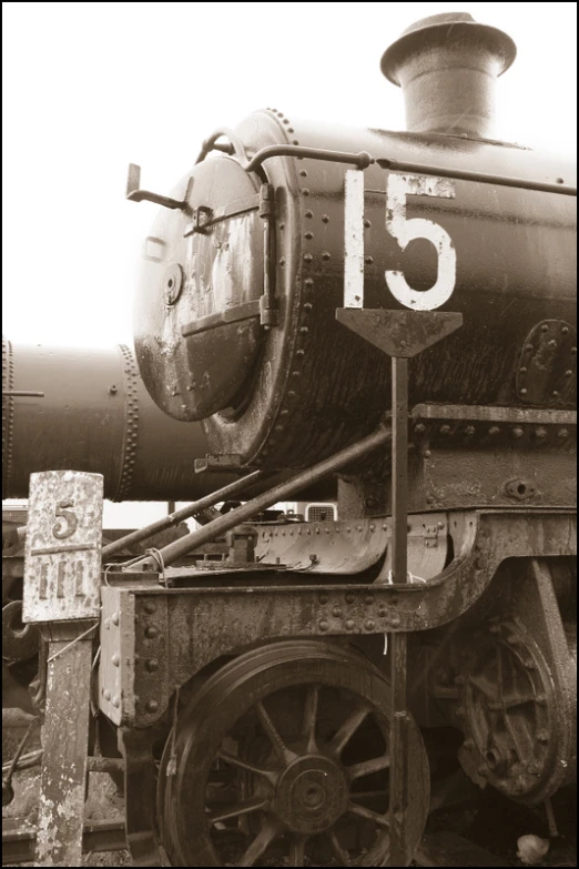 the large old fashioned train is painted black and white