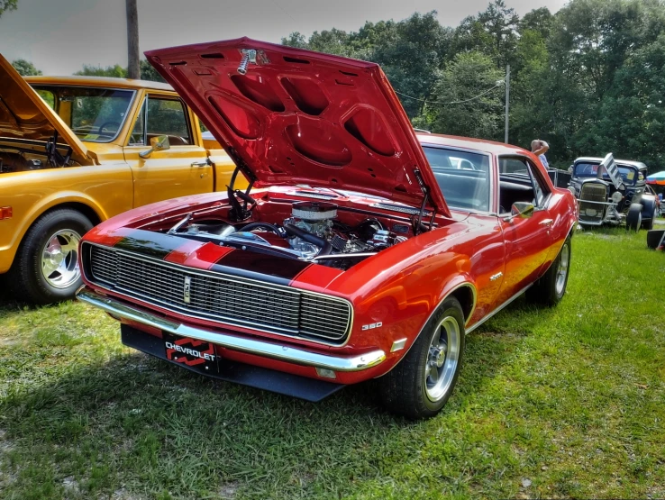 an old muscle car has its hood open