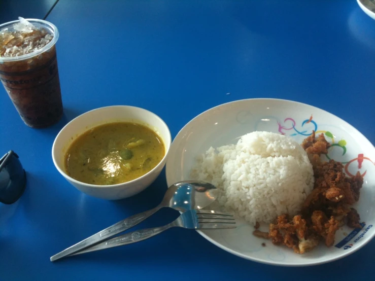 some rice and vegetables and soup on a table