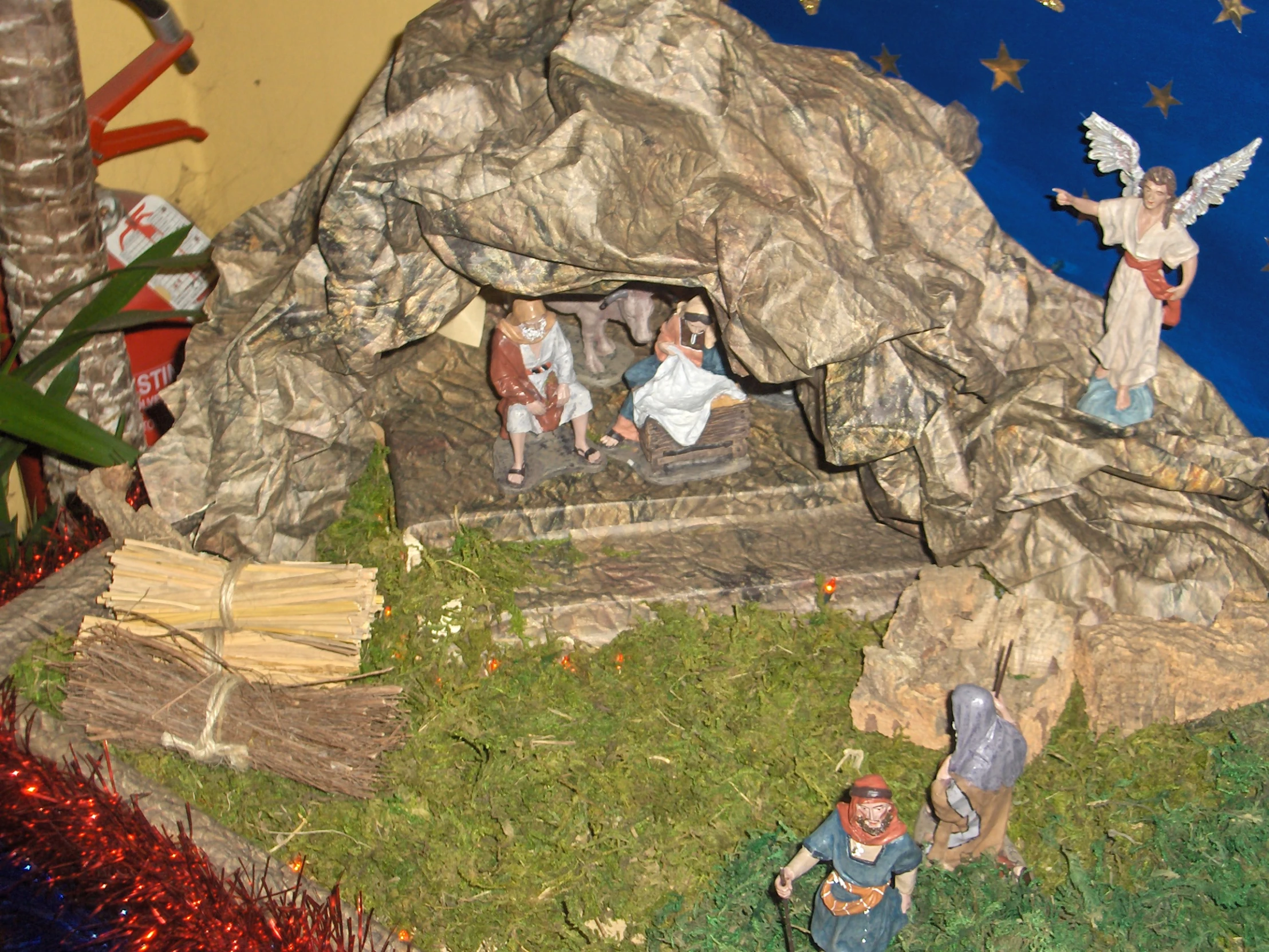 a display with a rock and figures, and green grass