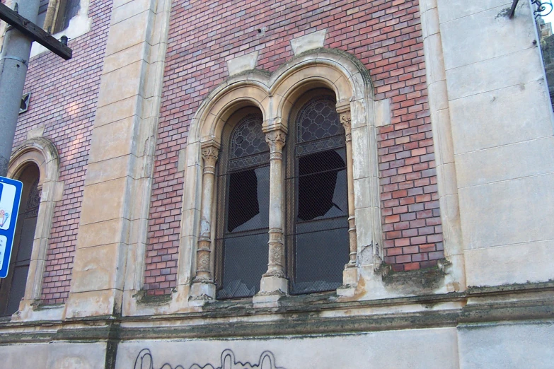 a sign is next to two windows of a building