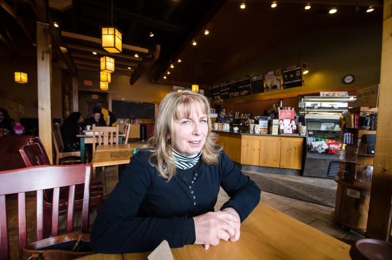 woman sitting at a dining table in a restaurant