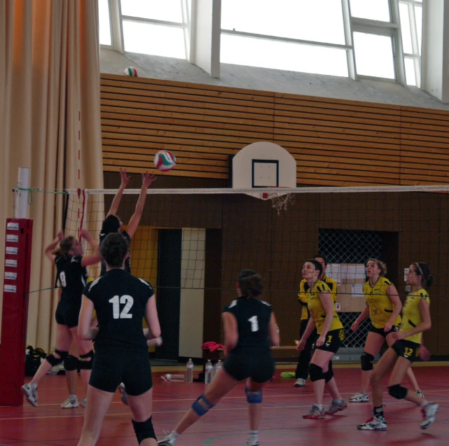 a group of women standing next to each other on a court