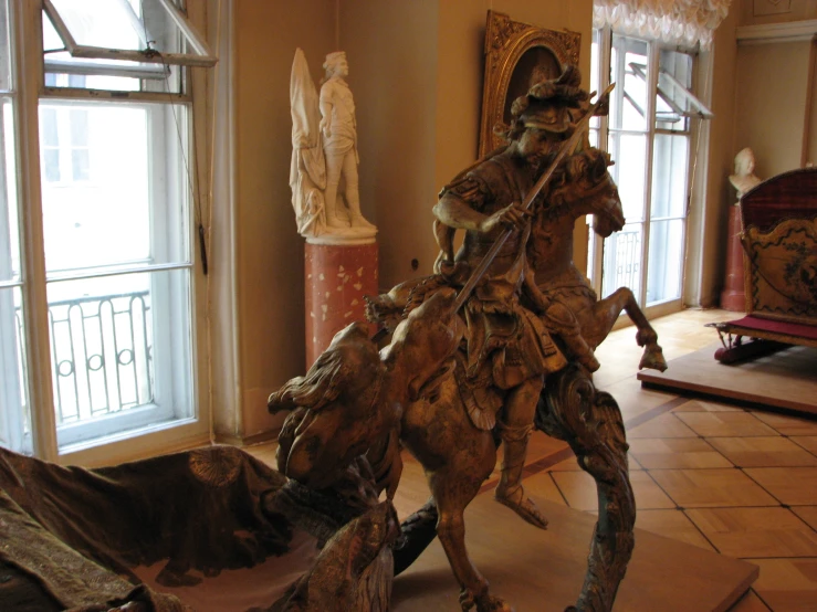 statue in front of large window in large room