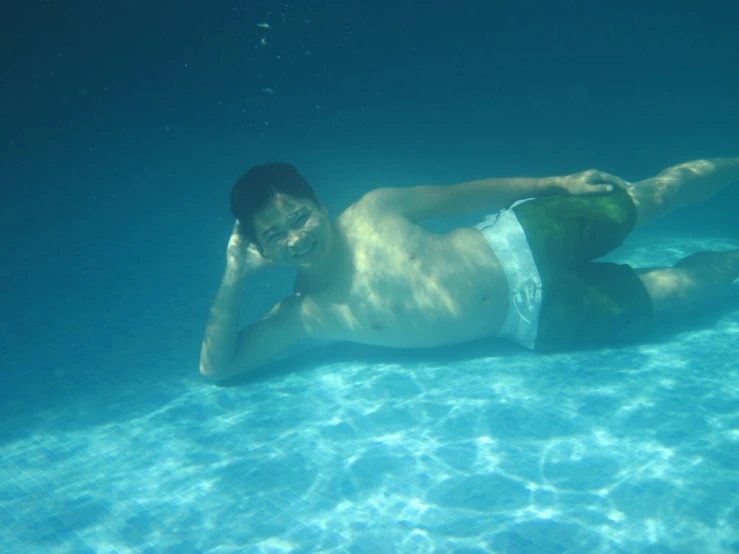 a man lying under water on his back