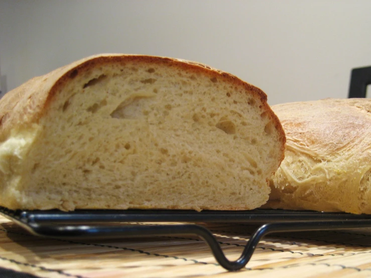 two loaves of bread are on a cooling rack