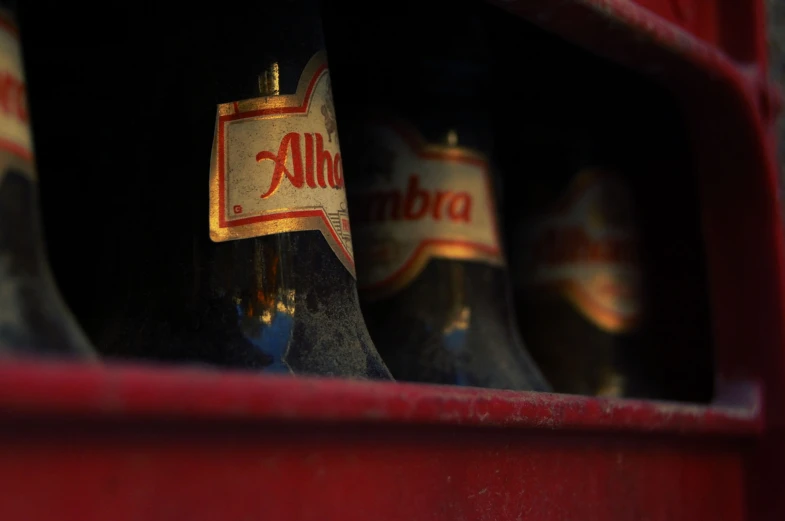 three bottles of alfana sitting on top of a shelf