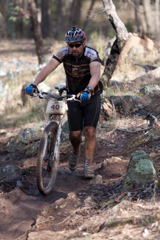 a man riding a bike down a dirt road