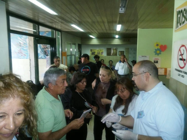 group of people gathered around talking to each other