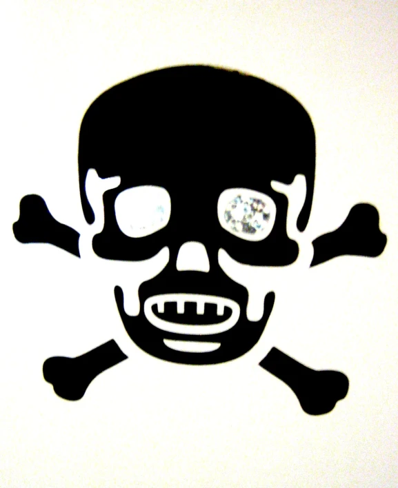 a black and white picture of a pirate face with a jewel in the middle of the cross bones