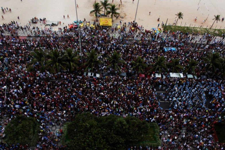 there are many people gathered on a crowded beach