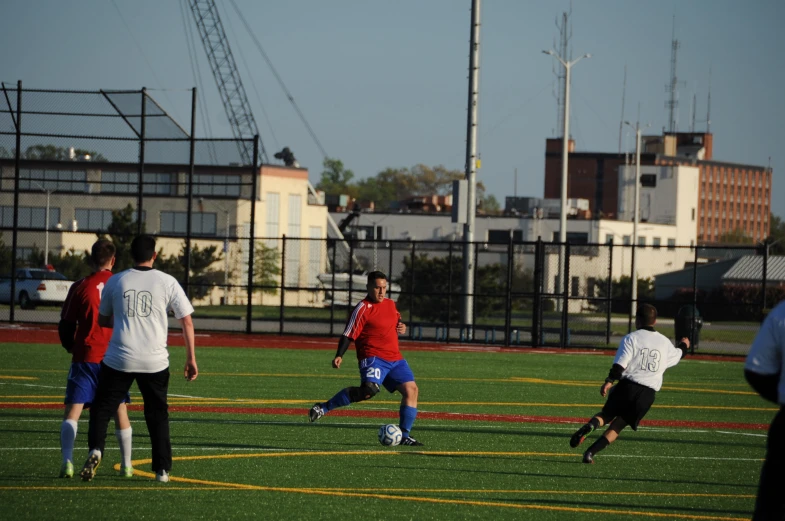 two men in the middle of playing soccer on grass