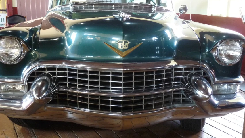 vintage, antique, green and gold car displayed in room