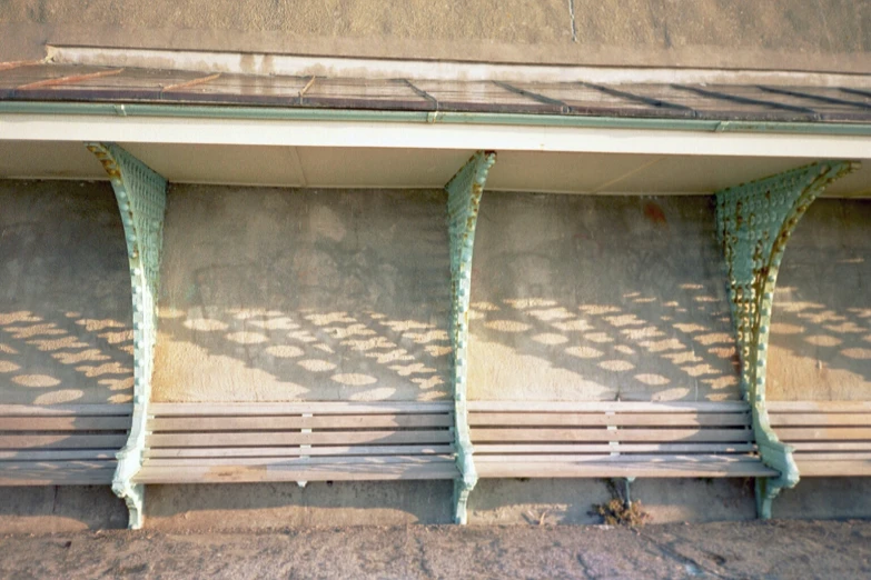 three metal benches on the outside of a building