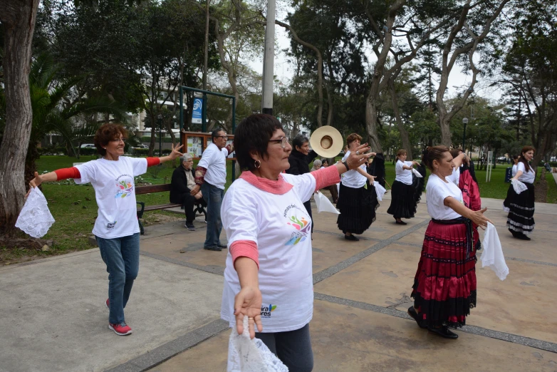 several people in mexican dresses holding and performing a musical routine